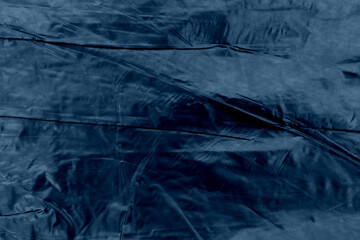 Dark blue glossy texture of crumpled metal. Scarlet, ribbed.