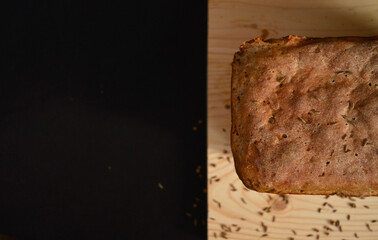 Sourdough homemade bread on a cutting board sprinkled with caraway seeds