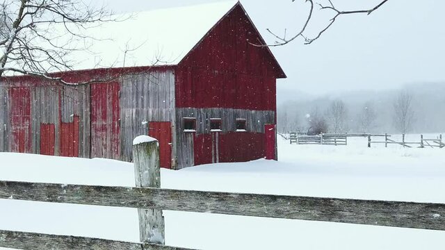 Old barn in snowy winter blizzard.