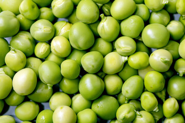 Macro food background with young sweet organic green peas. Top view