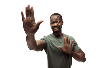 Dancing. Young african-american man with funny, unusual popular emotions and gestures on white studio background. Human emotions, facial expression, sales, ad concept. Trendy look inspired by memes.