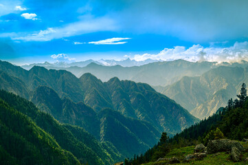 Mountain landscape with clouds, meadows. Himalayas peaks & alpine l from the trail of Sar Pass trek  Himalayan region of Kasol, Himachal Pradesh, India.