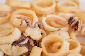 fried squids or octopus (calamari) isolated on white background