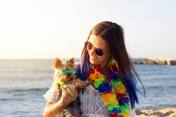 Yorkshire Terrier dog and beautiful young woman with blue hair and both with round retro sunglasses...