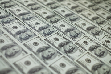Group of money stack of 100 US dollars banknotes a lot of is arranged in a beautiful, selective focus