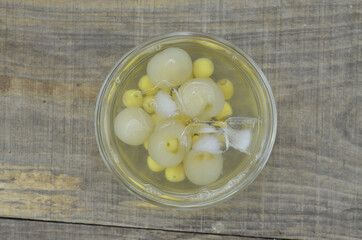 Lotus tea, longan with ice delicious in bowl on wooden table