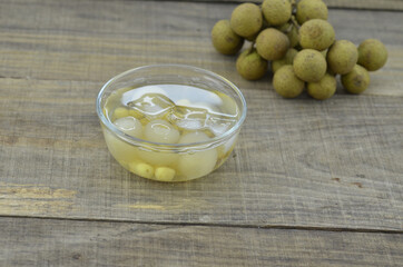 Lotus tea, longan with ice delicious in bowl on wooden table