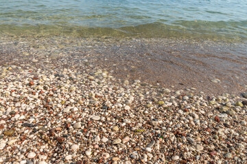 Sea wave on a sand and pebble shore