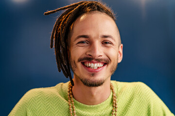 Close-up portrait of a young stylish man with dreadlocks