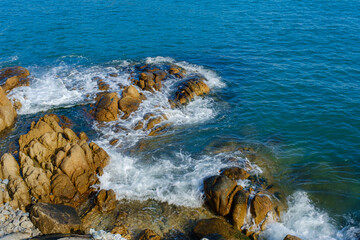 Sea waves splash on the rocks