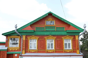 Vintage wooden rural house with ornamental windows, frames in Suzdal town, Vladimir region, Russia. Russian traditional national folk style in architecture. Suzdal landmark, view. Village, countryside