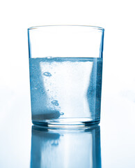 glass cup with water and a tablet that dissolves inside