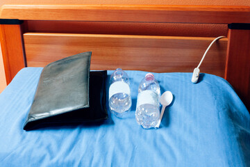 everything an old man in hospice need on daily basis - notebook of memories, a multipurpose spoon and two bottles of water