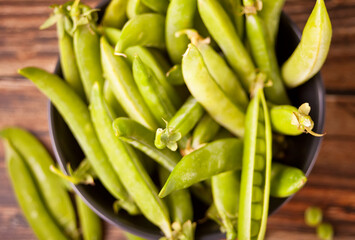 Organic fresh green peas and pea pods.