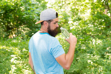 Every Sip Counts. mature guy in hat. thirsty hipster traveler. drinking water in forest outdoor...