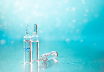 Ampoules on a beautiful bokeh background. Blurred photo of ampoules with injection liquid for...