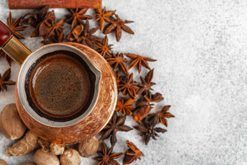 Close up of copper coffee turk on light textured surface