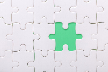 Fototapeta premium White puzzle background with one piece missing. Close-up. Concept success of business