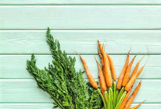 Carrot - Fresh, With Green Tops - On Green Table Top View Copy Space