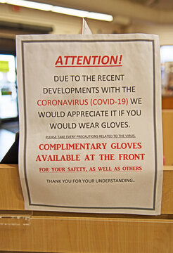 Due to the Covid-19 pandemic, a sign in a store in Arizona requires customers to wear gloves if they wish to handle the merchandise.