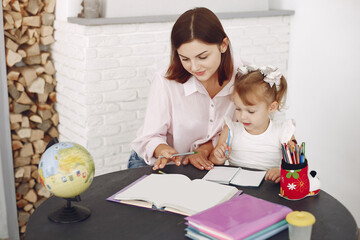 Fototapeta premium Tutor with pupil. Little girl studying. Private lesson.
