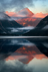 Lake Plansee in Austria near Reutte Heiterwang at sunrise with morning light alpenglow on the...