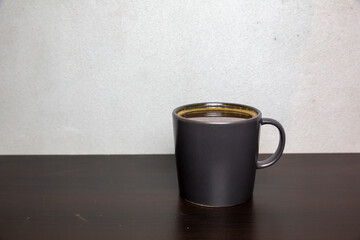 close up coffee cup on wooden table, selective focus