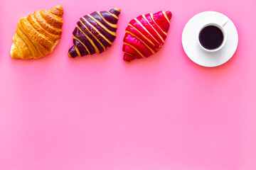 Set of coffee with croissants - chocolate, berry, classic - on pink top view