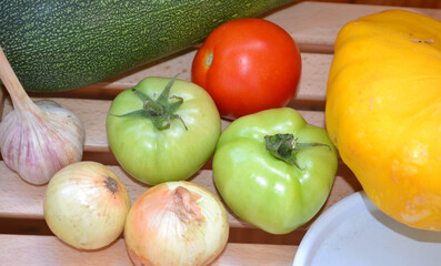 Autumn harvest. Green and red tomatoes, pumpkin, vegetable marrow. Ingredients for vegetable vegetarian ragout. Organic farm food. Autumn natural vitamins. 