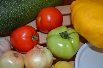 Autumn harvest. Green and red tomatoes, pumpkin, vegetable marrow, onions, garlic. Ingredients for vegetable vegetarian ragout. Organic farm food. Autumn natural vitamins. 