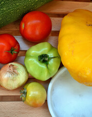 Autumn harvest. Green and red tomatoes, pumpkin, vegetable marrow, onions, garlic. Ingredients for vegetable vegetarian ragout. Organic farm food. Autumn natural vitamins. 