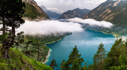 Lake Plansee in Austria Tirol in the morning with fog. Hiking in the alps near Reutte. Holiday 