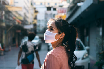 Fototapeta na wymiar Asian adult woman tan skin wear mask on face for new normal.