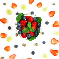 berry cocktail in a crystal glass with strawberries, blueberries, blueberries and mint close up