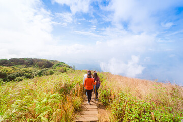 group asian woman traveler hiking and embracing nature from top of mountain in spring season
