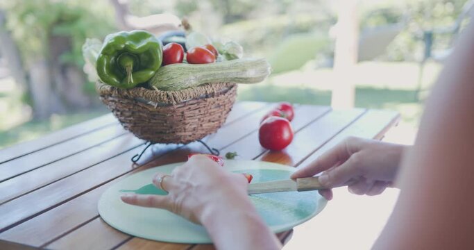 Woman cuts vegetables