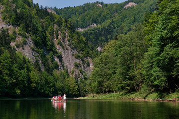 Raftsman rafts tourists on the Dunajec river gorge. Rafting on Dunajec river in Poland.