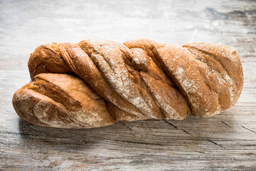 Freshly baked rustic bread on the rustic background. Selective focus. Shallow depth of field.