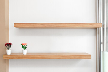 Flowers in a vase on a wooden shelfs, Wooden shelves on the wall.
