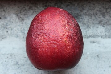 Overripe peach.Dried Peach with rotten, crumpled and wilted skin
wrinkled dried peach on a stone background
