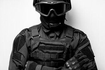 SWAT in black uniform, face mask and bulletproof vest. Tactical helmet vest goggles. Spec ops Riot police officer Defense and protection of law enforcement officers. black and white photo