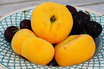 Naklejka na ściany i meble Bowl of stone fruit with apricots, peaches and cherries