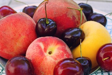 Naklejka na ściany i meble Bowl of stone fruit with apricots, peaches and cherries