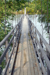 Wooden pedestrian bridge across Bolshaya Ussurka river. Dalniy Kut village, Primorsky Krai, Far East, Russia.