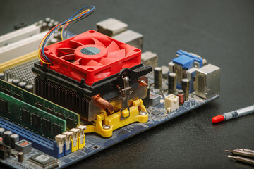 computer motherboard with a cooler on the table repair equipment