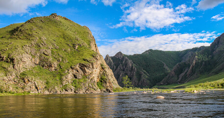 Evening sun and mountain reflection on a Mongolian River, above rapids