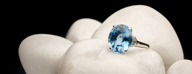 Classy blue ring close-up on top of white stones