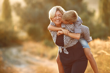 Mother with son. Family in a spring field.