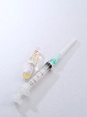 Close up view of the ampule with medicine and syringe on white back 