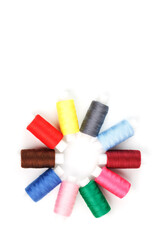 Colorful cotton craft sewing threads in flower shape isolated on white background.